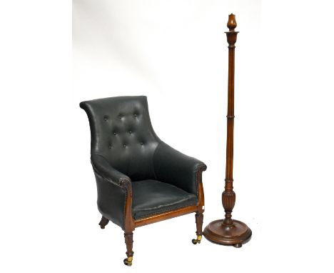An early 19th century rosewood bergère chair with green leather button upholstery, carved scrolling frame and turned front le