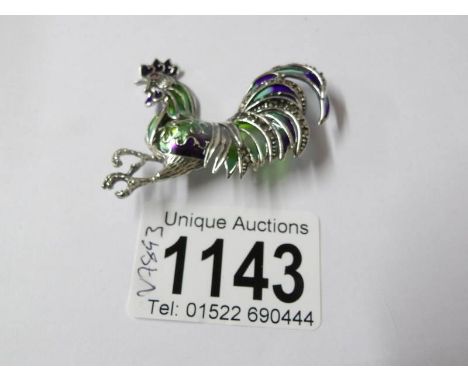 A silver and enamel cockerel brooch.