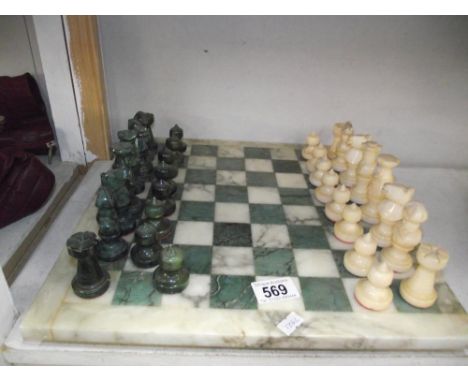 A polished stone chess set, some pieces a/f.