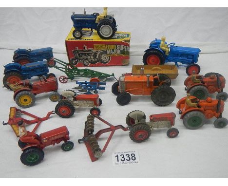 A mixed lot of die cast tractors and farming implements by Britain's, Dinky, Corgi etc.,