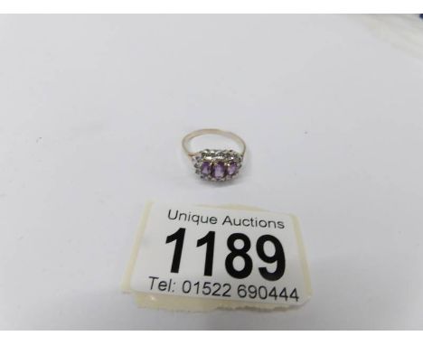 A 9ct yellow gold 3 stone amethyst and diamond oval ring.