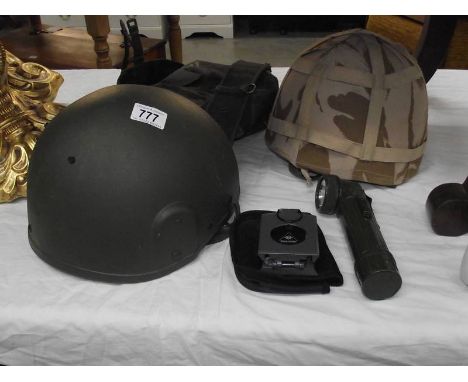 A Konustar compass, 2 military helmets, a belt with pouch and torch.