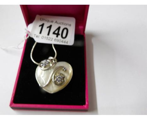 A silver and blister pearl heart shaped pendant necklace.