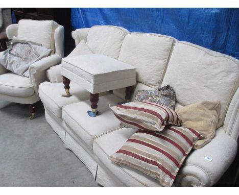 A 3 seater settee with matching arm chair and a pouffe