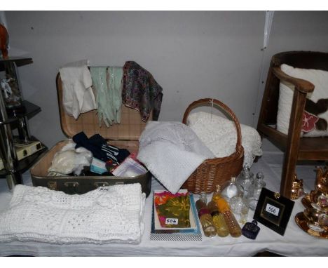A small vintage case of miscellaneous items including gloves, perfume bottles, household textiles and wicker basket.