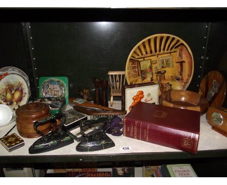 A mixed shelf of wooden items, collectable tins, large plaster plaque etc.,