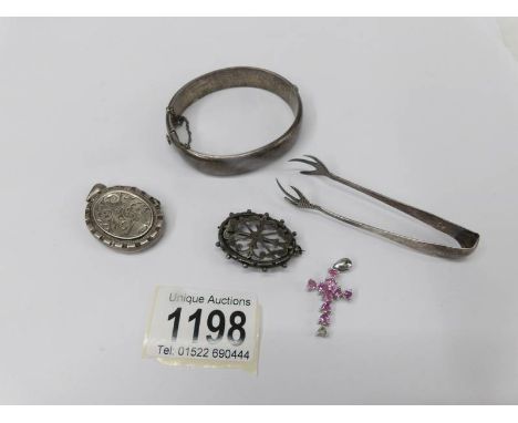 A hall marked silver bangle, sugar tongs, oval brooch, locket and 925 silver cross.