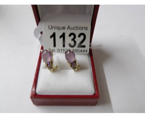 A pair of 10ct yellow gold amethyst and diamond earrings.