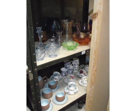 2 shelved of coloured glass including art deco trinket set, Carnival glass dish, Langley retro style tea set and a good selec