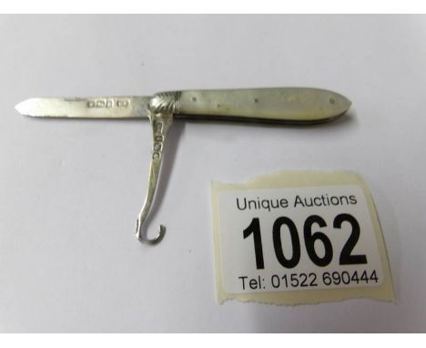 A silver and mother of pearl pocket knife with button hook.