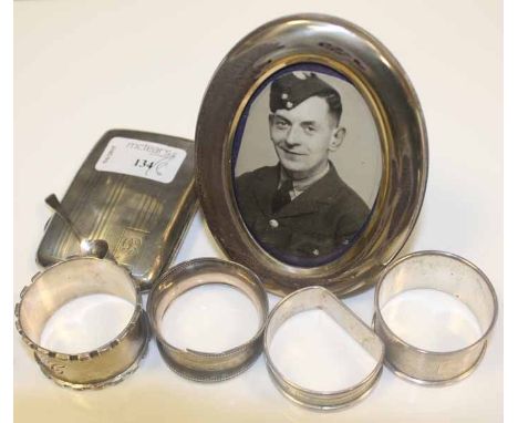 OVAL SILVER PHOTOGRAPH FRAME AND A CIGARETTE CASE  
together with four silver napkin rings 