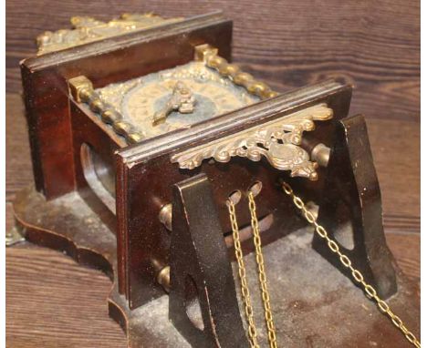 20TH CENTURY WALL MOUNTED BRACKET CLOCK
with brass mounts and figure of Atlas, 52cm long