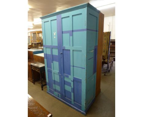 A painted pine two door school cupboard