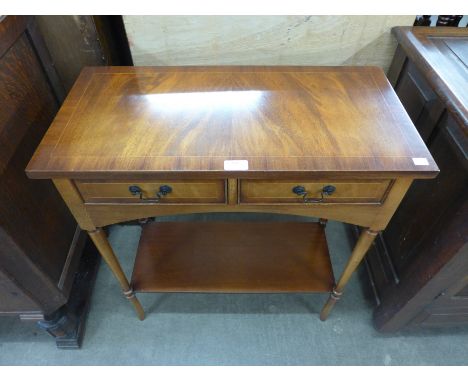 A mahogany two door side table