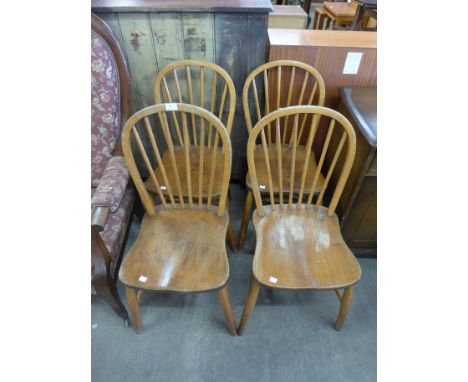 A set of four Ercol style elm seated chairs