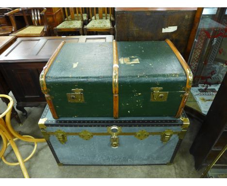 A banded travel trunk and a steamer trunk