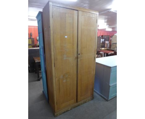 An oak two door school cupboard