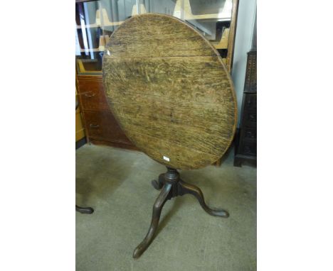 A George III oak circular tilt-top tripod table