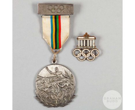 A 1936 Olympic enamel lapel badge inscribed 1936, XI. Olympiade Berlin and a 1936 Berlin Olympic lapel badge with ribbon and 