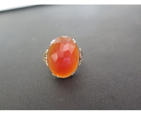 A faceted carnelian single-stone ring - With foreign marks for gold - Ring size L - Weight approx 4.8gms
Condition Report: Go