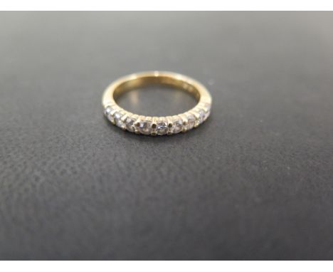 An 18ct gold brilliant-cut diamond nine-stone ring - Total diamond weight 0.65ct, stamped to band - Hallmarked London - Ring 