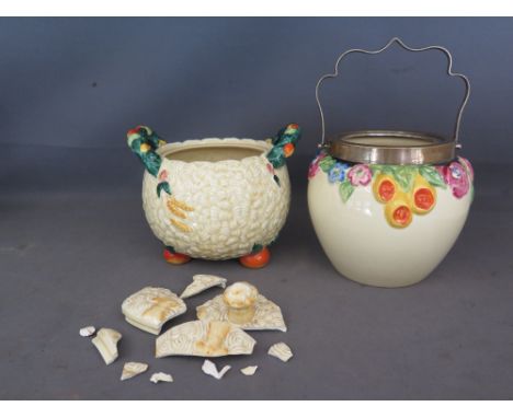 A Clarice Cliff Celtic Harvest biscuit jar and cover - cover in various pieces - a Clarice Cliff biscuit jar with no cover, a