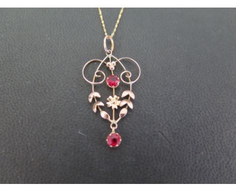 An early 20th century 9ct gold paste-set pendant - Length 4cms - Weight approx 1.3gms - Suspended from a fancy-link chain - S