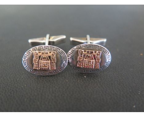 A pair of cufflinks - Of bi-colour design with mythological panel within a Greek key surround - Stamped 18K 925 - Weight appr