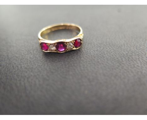 An 18ct gold ruby and diamond five-stone ring - The alternating old-cut diamonds and circular rubies to the plain band - Hall