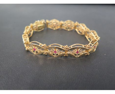 A ruby set panel bracelet - With filigree detail - Stamped 750 - Length 19cms - Weight approx 22.1gms
Condition Report: Good 