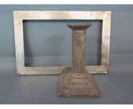A hallmarked silver candlestick with half fluted column - weighted base London 1899 - Height 13 cm and a silver photo frame f