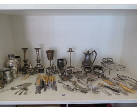 A collection of silver plated ware to include Sheffield plate candlestick cocktail shaker, cutlery etc