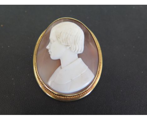 SAULINI a 19th centry shell cameo brooch - Carved to depict the profile of a young man within a plain surround with bead deta