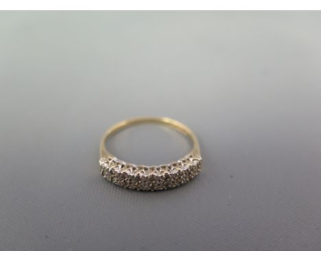 A 9ct and diamond half eternity ring numerous small stones in a white gold setting with yellow gold shank - size Q 
Condition