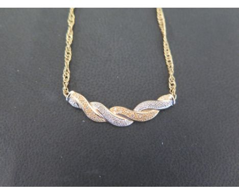 A 14ct gold diamond twist pendant necklace - To the fancy-link chain - Hallmarked Sheffield - Length 45cms - Weight approx 6.