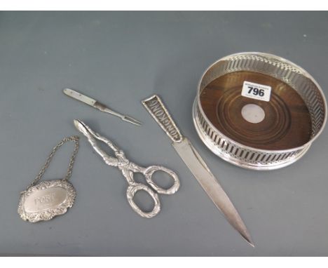 A silver Port label - Birmingham 2003, a silver rimmed coaster - London 1988 and a pair of silver scissor tongs - Birmingham 