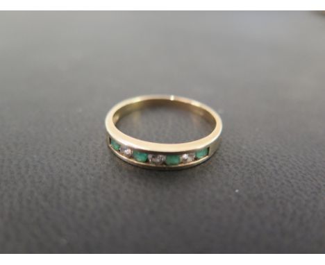 A 9ct gold emerald and diamond band ring - Hallmarked London - Ring size P - Weight approx 1.7gms
Condition Report: Good - Wi