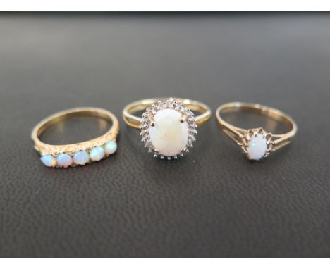 Three 9ct gold opal rings - To include a five-stone, a single-stone and an opal and diamond cluster - Hallmarked Birmingham a