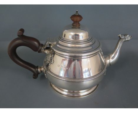 An early 20th century silver teapot with an animal spout and wooden handle - impressed marks A Bros 1923 Birmingham - Weight 