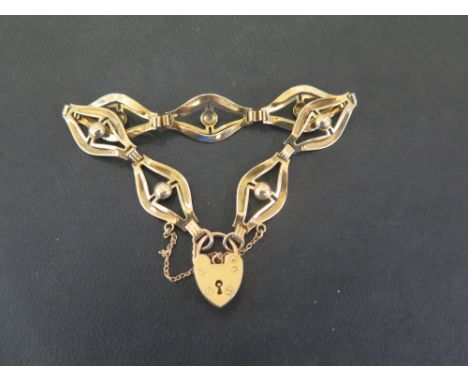 A 9ct gold openwork panel bracelet - To the padlock clasp - Hallmarked Birmingham - Length 18cms - Weight approx 9.2gms
Condi