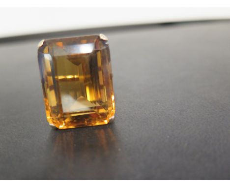 A citrine single-stone ring - The rectangular citrine to the plain band - Tests as 9ct gold - Ring size O - Weight approx 17.