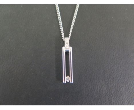 A 9ct gold openwork diamond pendant - Suspended from a curb-link chain - Hallmarked Birmingham - Length of pendant 2.5cms - L