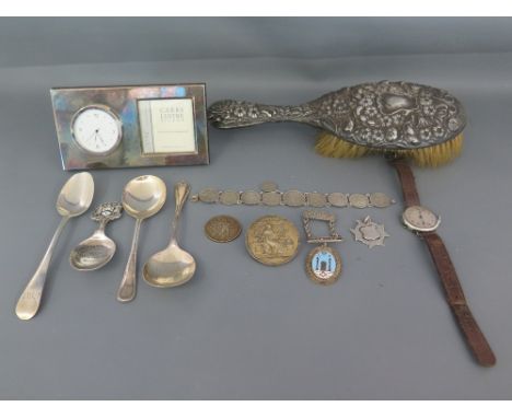 A mixed lot of silver hallmarked items including spoons, coins, Masonic medallion, wristwatch, modern table clock and photo f
