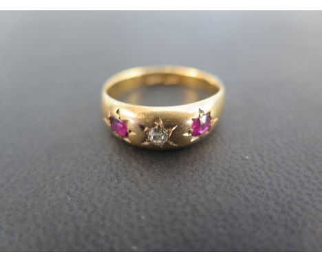 An early 20th century 18ct gold old-cut diamond and ruby band ring - Ring size Q - Weight approx 3.8gms
Condition Report: Goo