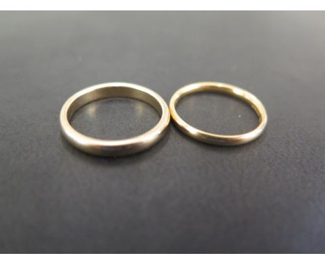 An 18ct gold band ring - Hallmarked Sheffield - Ring size M - Weight approx 2.1gms - Together with a 9ct gold band ring - Hal