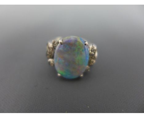 An opal and diamond dress ring - The oval opal to the single-cut diamond scroll shoulders - Stamped 14K - Ring size K - Weigh