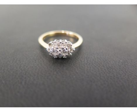 A diamond cluster ring - Stamped 750 - Ring size M 1/2 - Weight approx 3.1gms
Condition Report: Good to fair - With light sur