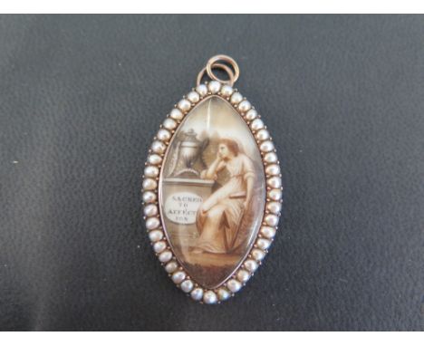 A Georgian gold memorial pendant - Set with a miniature painted on ivory, depicting a seated lady holding an anchor, gazing a