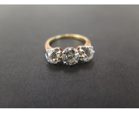 A diamond three-stone ring - The old-cut diamonds to the tapered shoulders and plain band - Estimated total diamond weight 2.