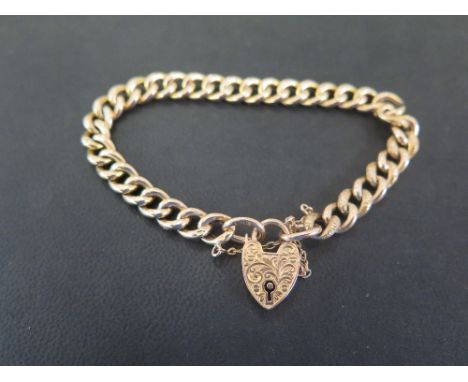 A 9ct gold curb-link bracelet - With textured detail to the padlock clasp - Hallmarked Birmingham - Length approx 19cms - Wei